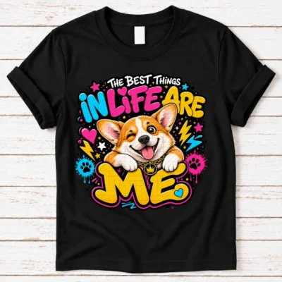 corgi pride shirt artwork with a winking orange-and-white corgi, tongue out, crown medallion, neon lettering, hearts, lightning bolts, and paw prints.