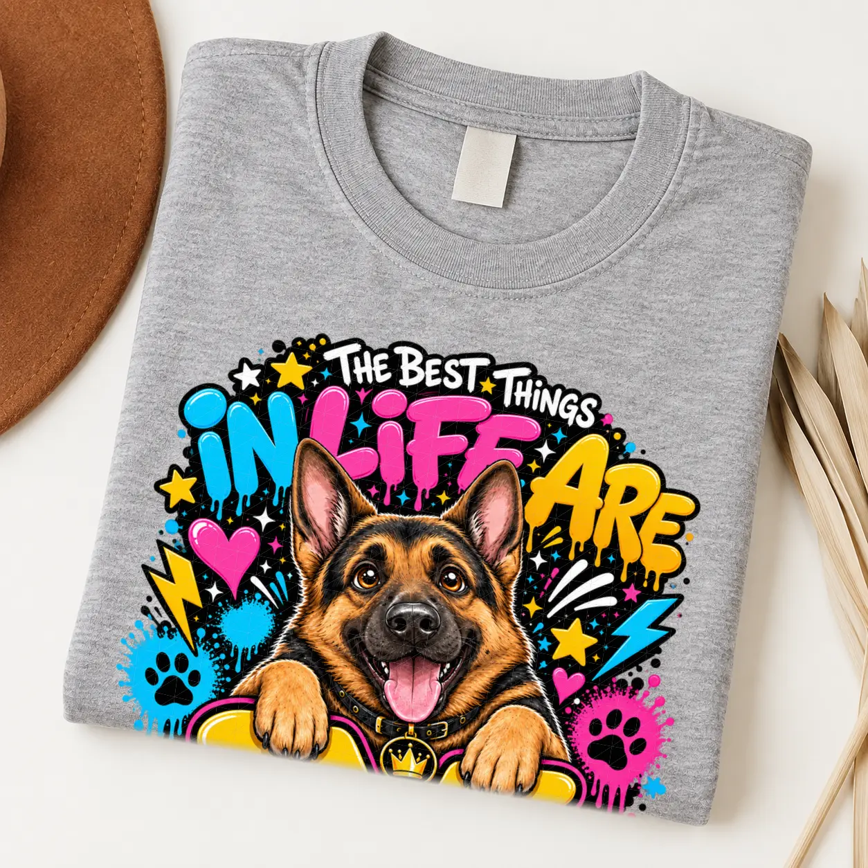 German Shepherd pride shirt artwork with a smiling black-and-tan shepherd, tongue out, crown medallion, neon graffiti lettering, paw prints, and bolts.