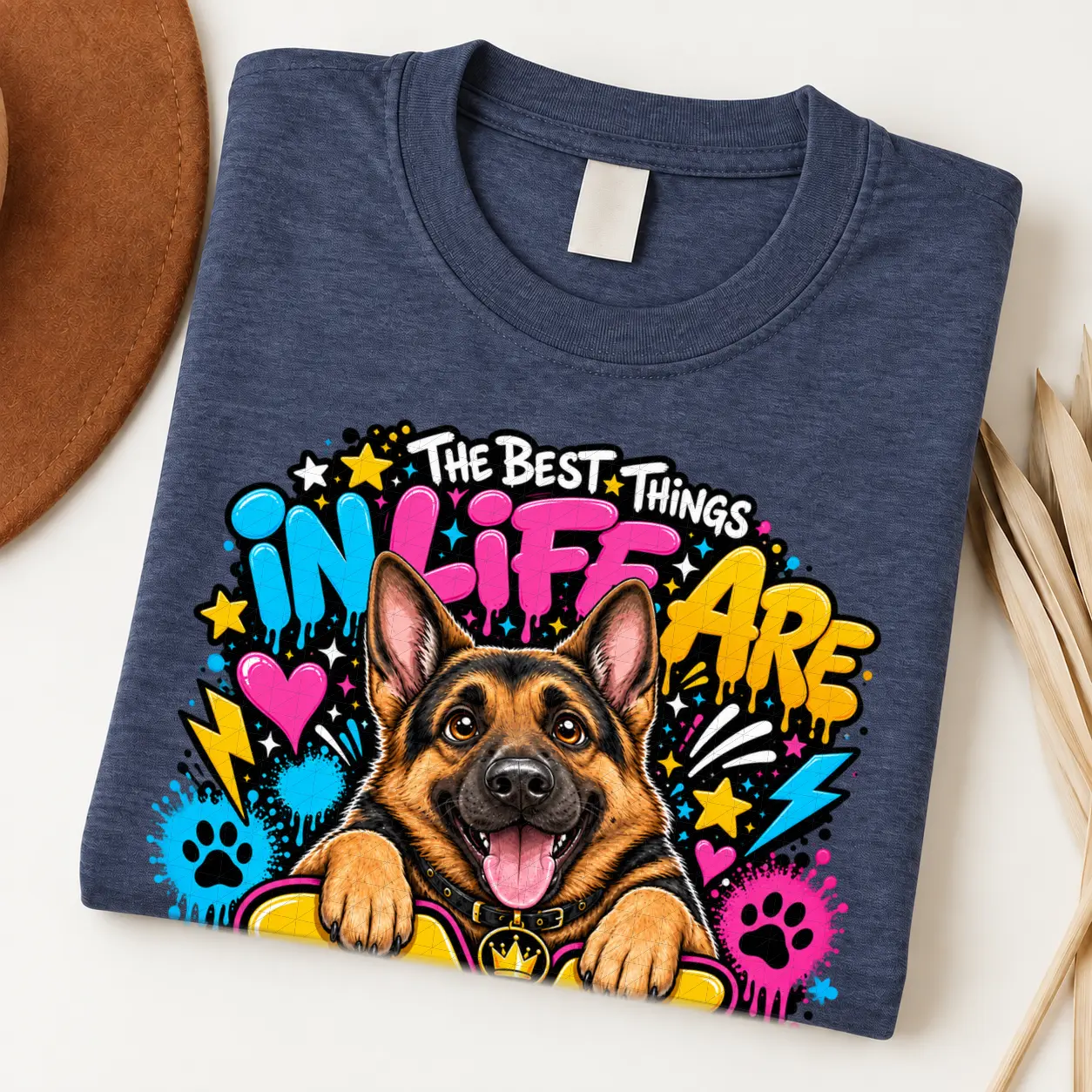 German Shepherd pride shirt artwork with a smiling black-and-tan shepherd, tongue out, crown medallion, neon graffiti lettering, paw prints, and bolts.