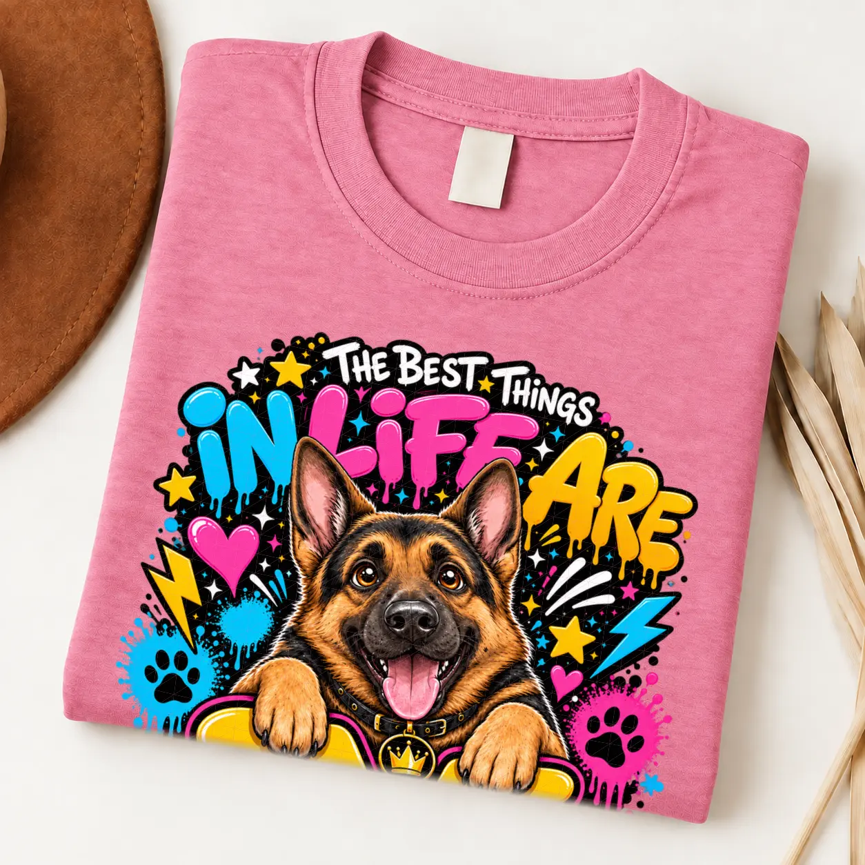 German Shepherd pride shirt artwork with a smiling black-and-tan shepherd, tongue out, crown medallion, neon graffiti lettering, paw prints, and bolts.
