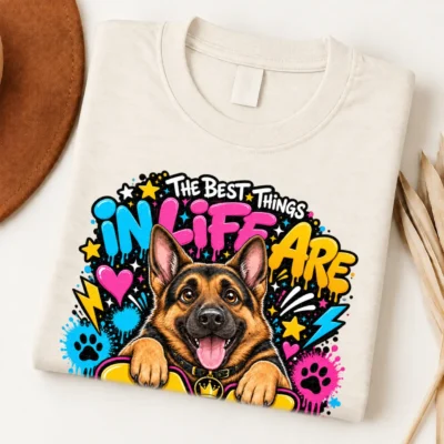 German Shepherd pride shirt artwork with a smiling black-and-tan shepherd, tongue out, crown medallion, neon graffiti lettering, paw prints, and bolts.