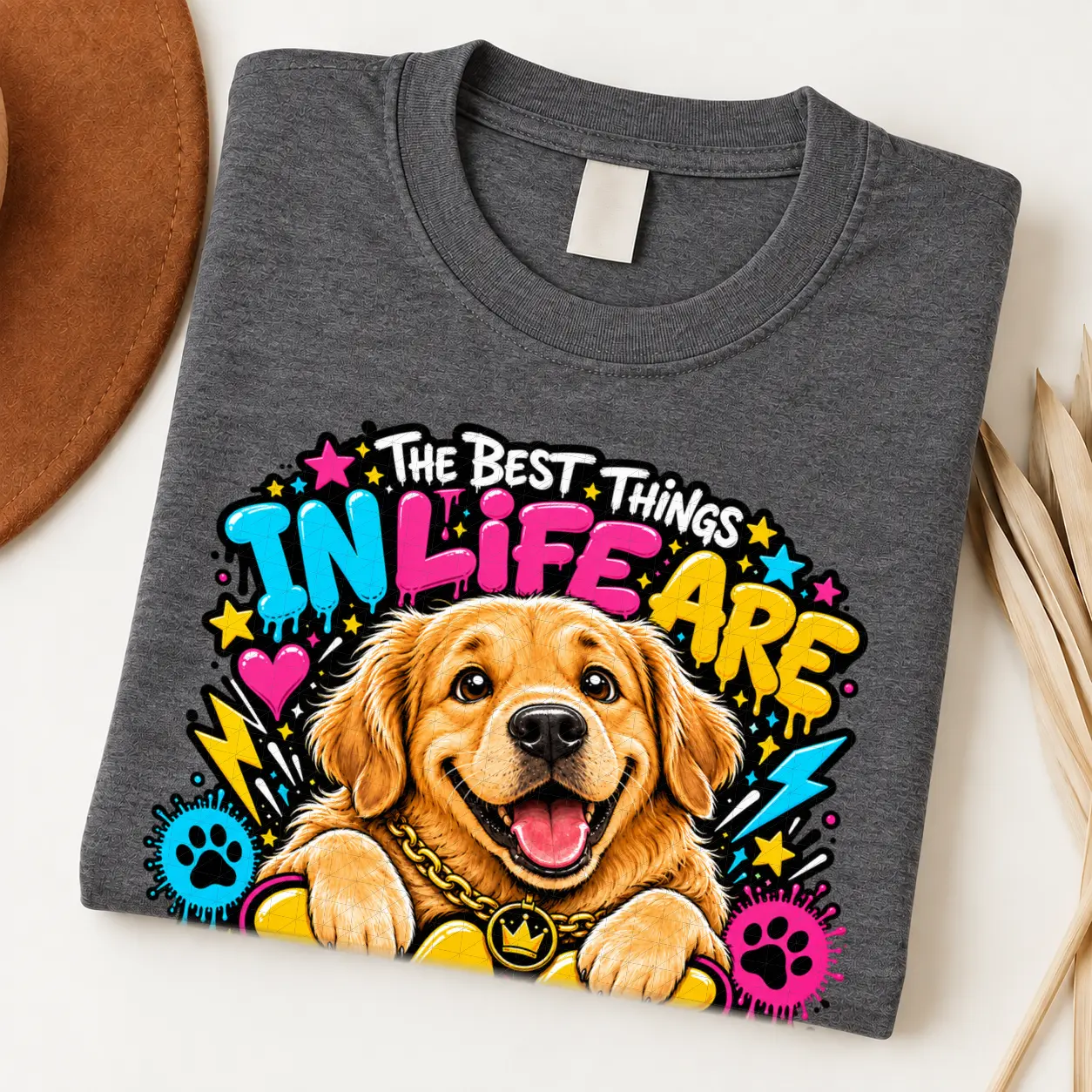 Golden Retriever pride shirt artwork with a smiling golden dog, tongue out, crown medallion, bold neon lettering, hearts, paw prints, and lightning bolts.