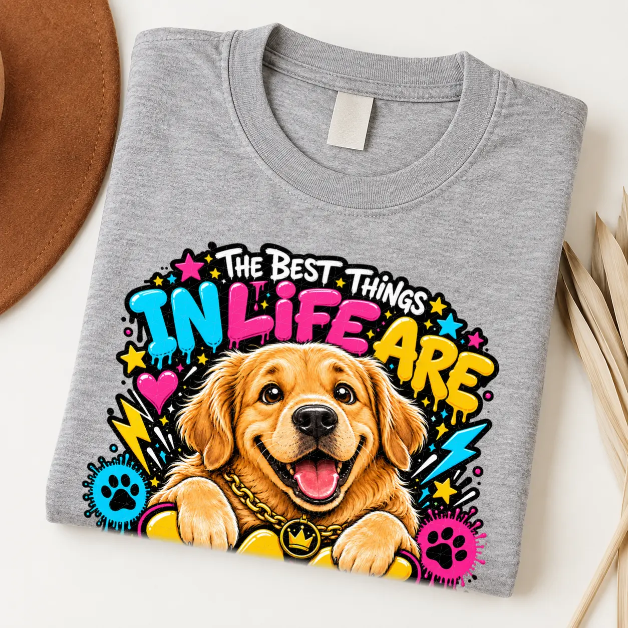 Golden Retriever pride shirt artwork with a smiling golden dog, tongue out, crown medallion, bold neon lettering, hearts, paw prints, and lightning bolts.