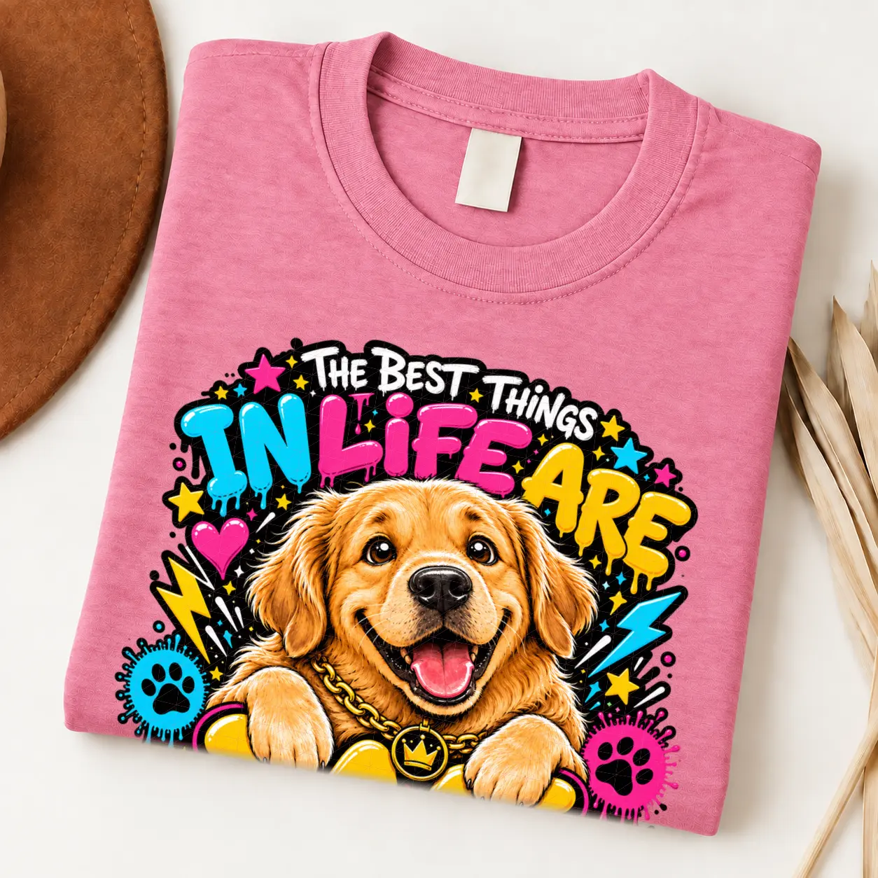 Golden Retriever pride shirt artwork with a smiling golden dog, tongue out, crown medallion, bold neon lettering, hearts, paw prints, and lightning bolts.