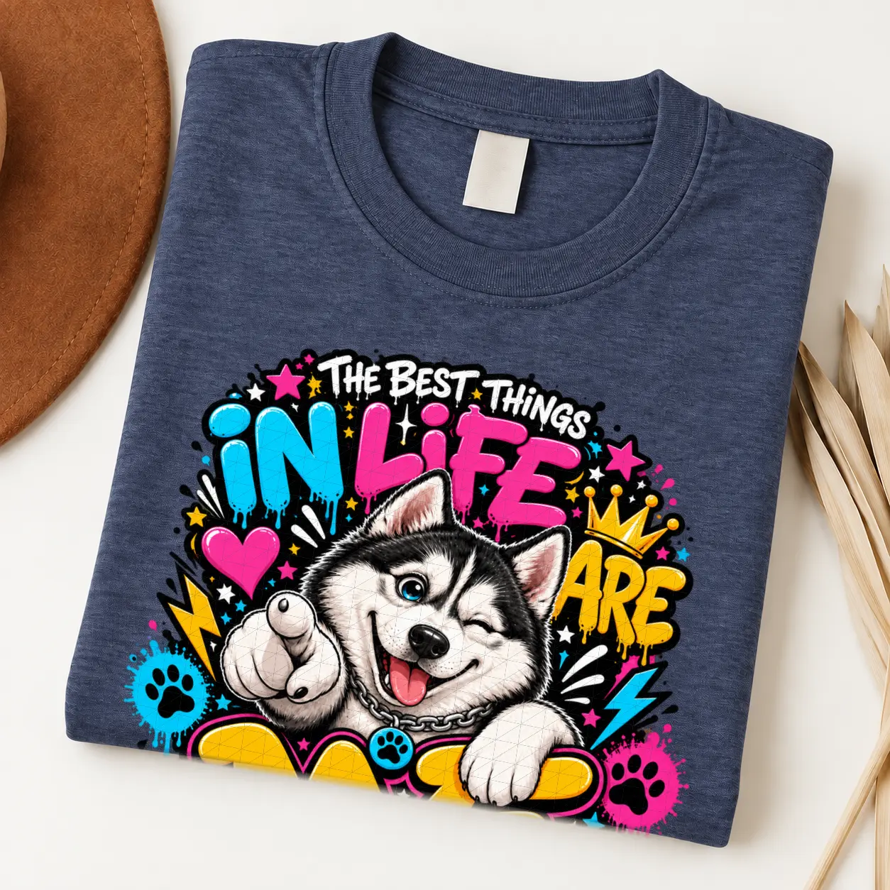 Husky pride shirt artwork with a winking black-and-white Husky, pointing paw, blue eye, crown medallion, neon lettering, bolts, hearts, and paw prints.