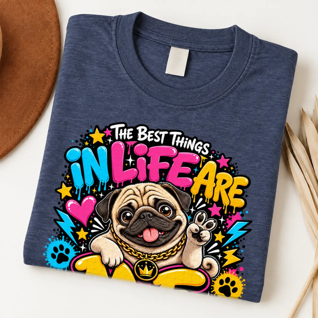 Pug pride shirt artwork with a smiling fawn pug, tongue out, peace-sign paw, crown medallion, neon lettering, hearts, paw prints, and lightning bolts.