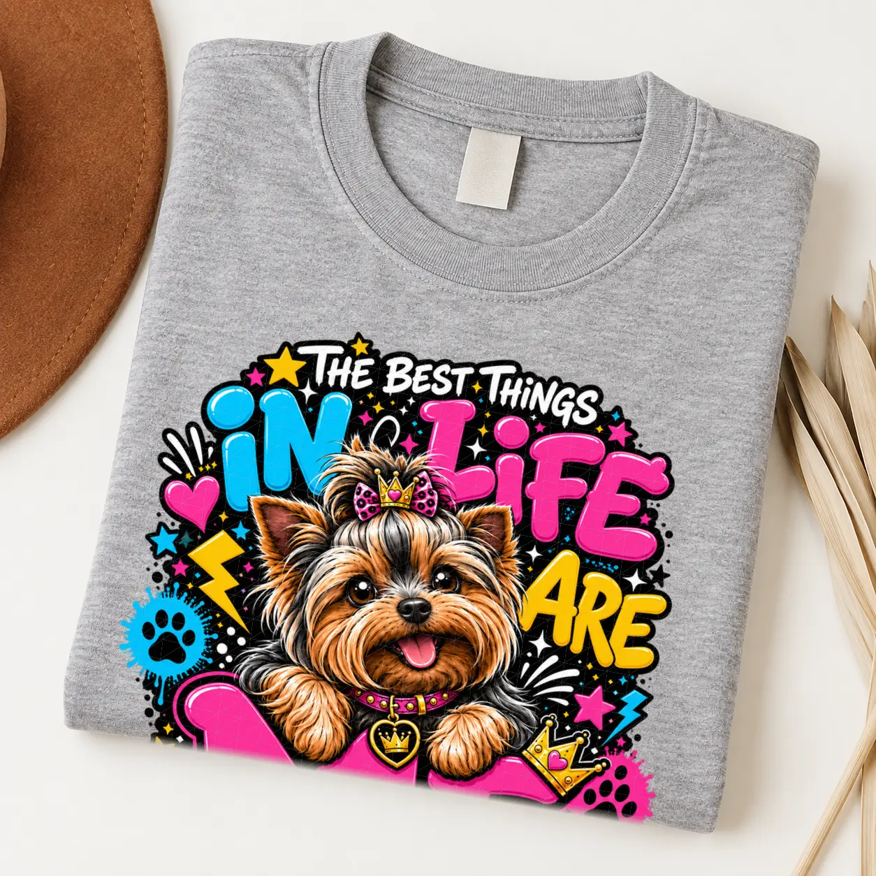 Yorkie pride shirt artwork with a Yorkshire Terrier wearing a pink bow, small crown, pink collar, crown medallion, neon lettering, hearts, and paw prints.